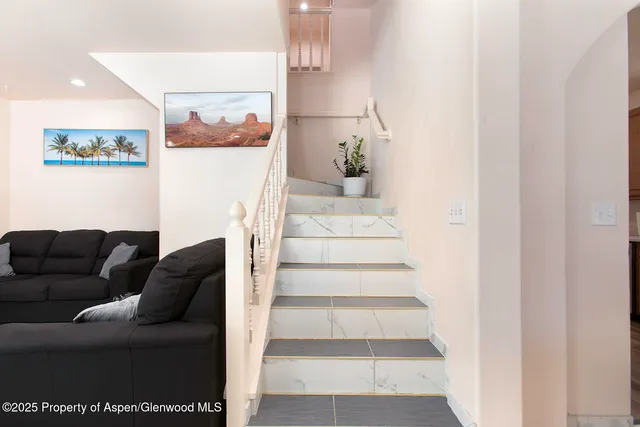 a living room with furniture and a painting on the wall