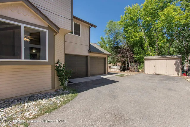 a view of a house with a yard and garage