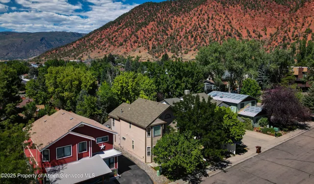 an aerial view of a house with yard and outdoor seating