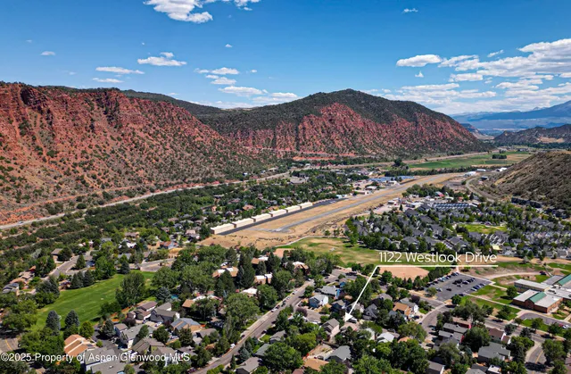 an aerial view of a house with a yard and garden