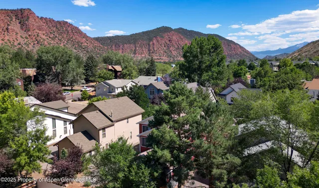 an aerial view of a house with a yard