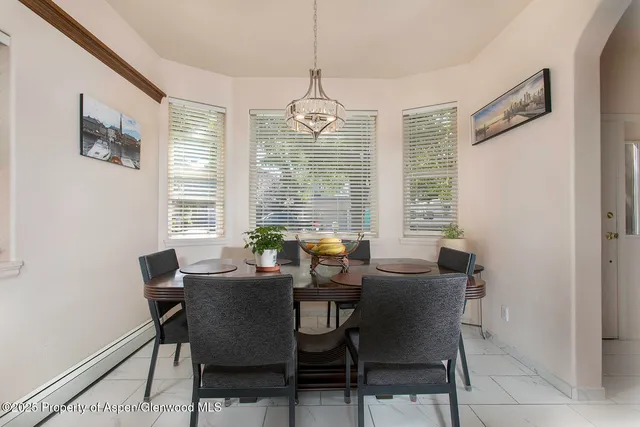 a view of a dining room with furniture and windows