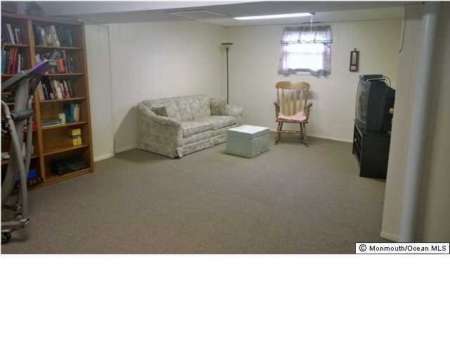 70 Darien Road Howell, NJ 07731 - Photo 17 of 26 a living room with furniture and a flat screen tv