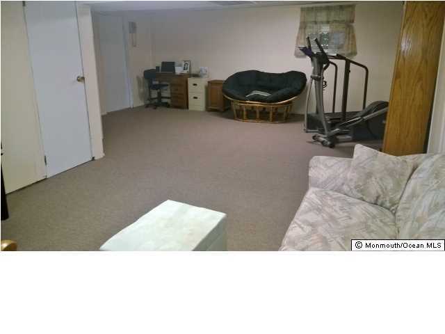70 Darien Road Howell, NJ 07731 - Photo 18 of 26 a living room with furniture and a window