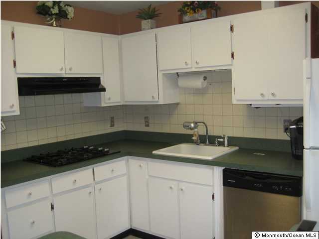 70 Darien Road Howell, NJ 07731 - Photo 2 of 26 a kitchen with granite countertop white cabinets and a sink