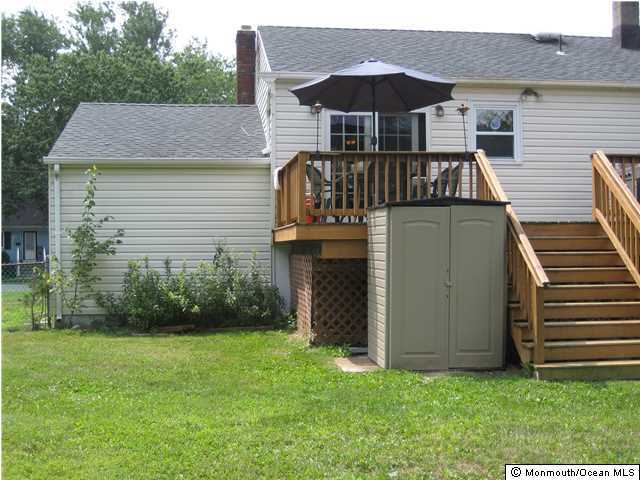 70 Darien Road Howell, NJ 07731 - Photo 24 of 26 a front view of house with yard and island in the background
