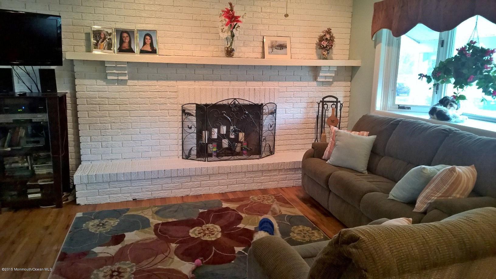 70 Darien Road Howell, NJ 07731 - Photo 7 of 26 a living room with furniture and a fireplace