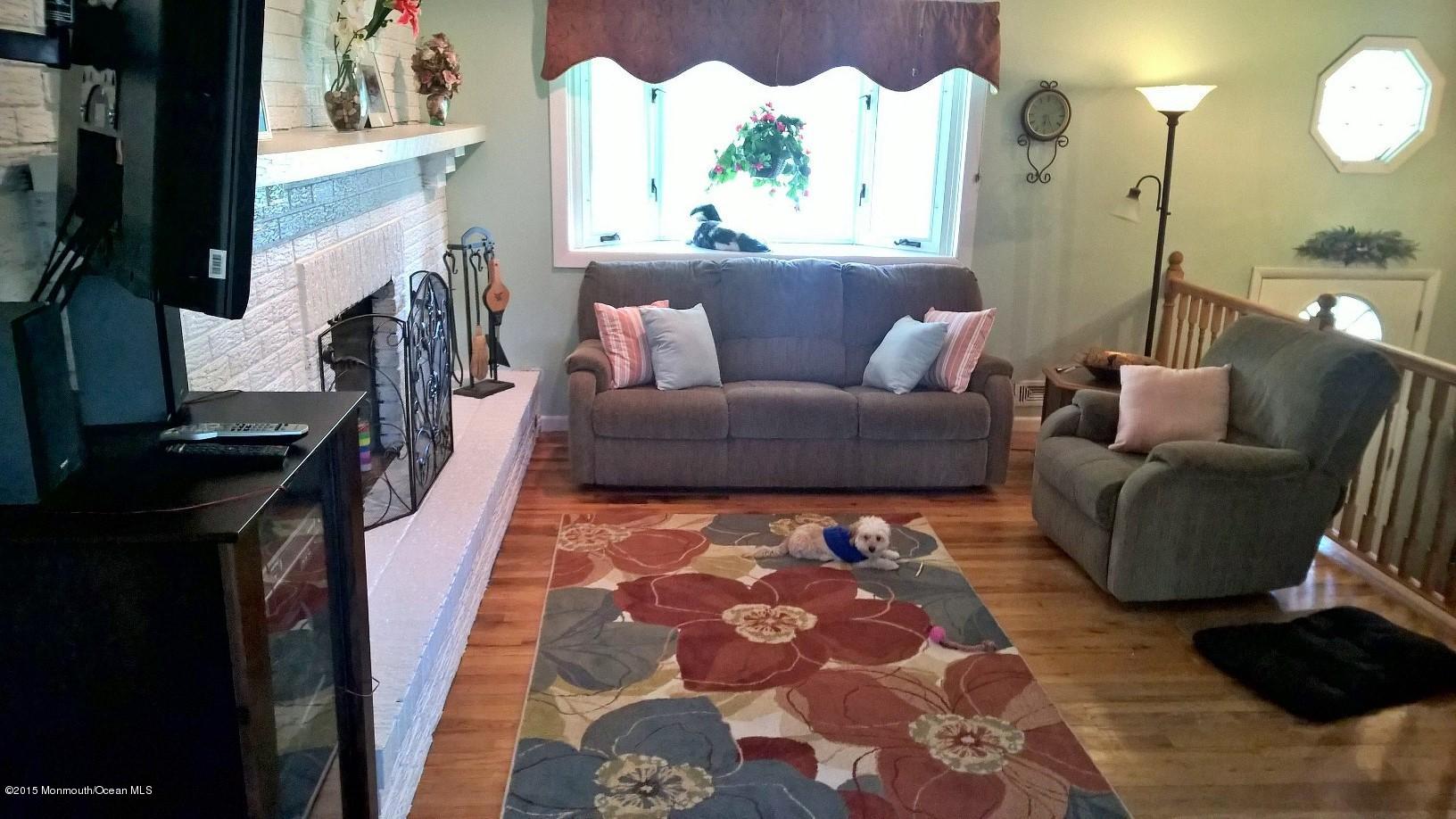 70 Darien Road Howell, NJ 07731 - Photo 8 of 26 a living room with furniture and a flat screen tv