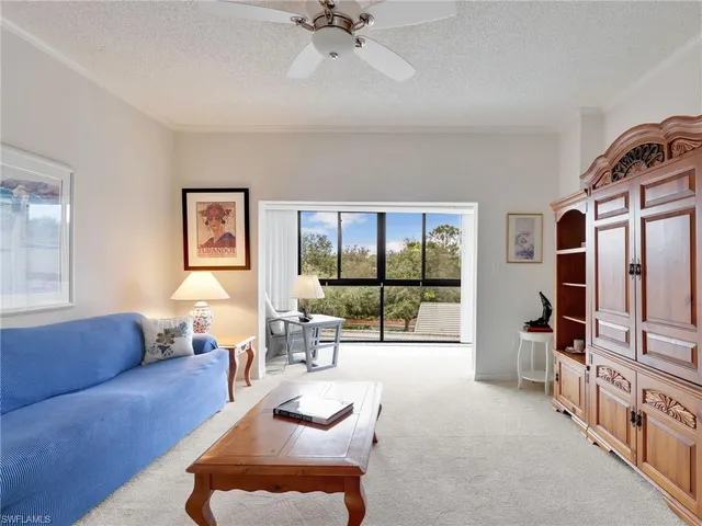a living room with furniture large window and flat screen tv