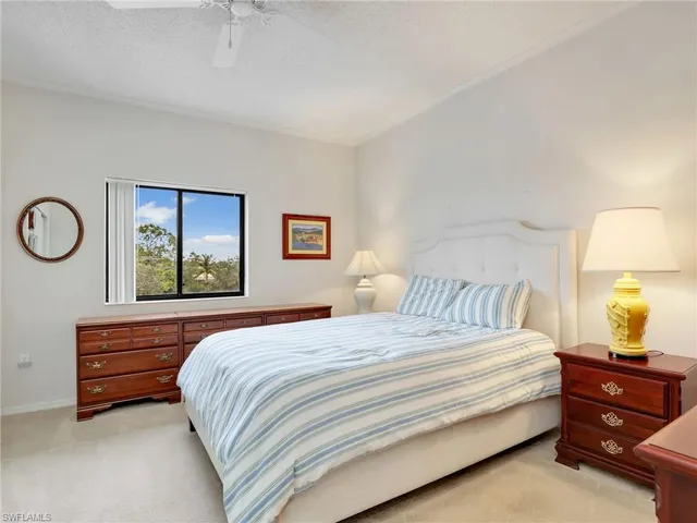 a bedroom with a bed and a lamp