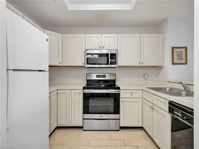 a kitchen with cabinets stainless steel appliances and a sink