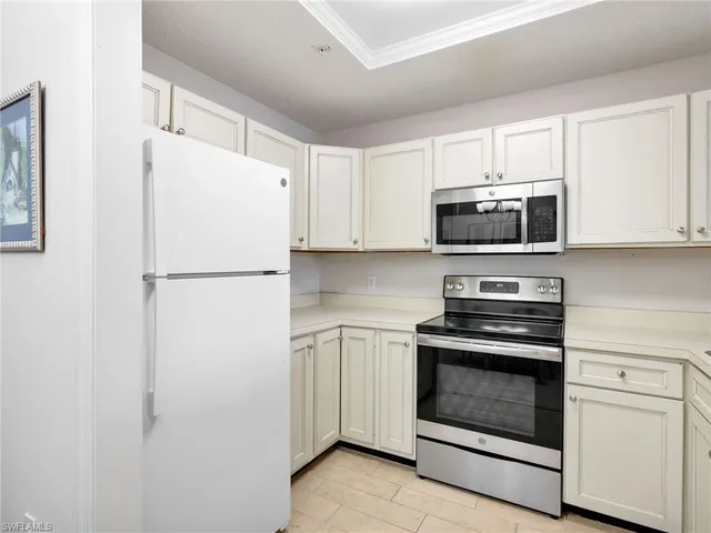 a white refrigerator freezer and a stove top oven