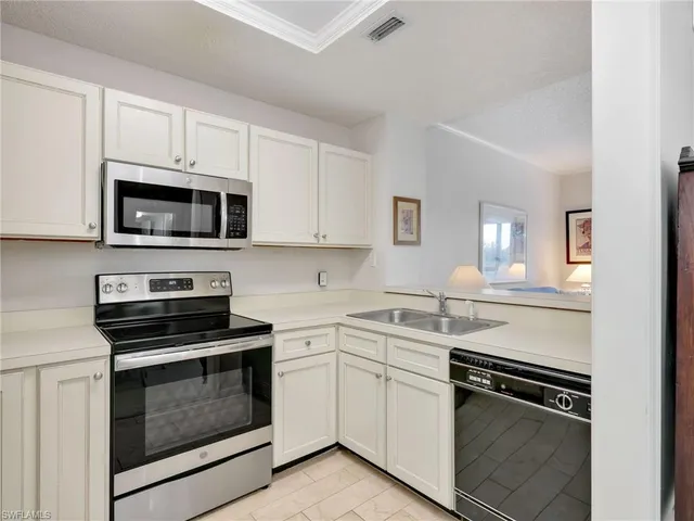 a kitchen with cabinets stainless steel appliances and white cabinets