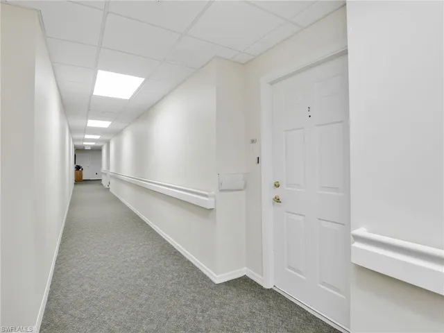 a view of a hallway with a white walls