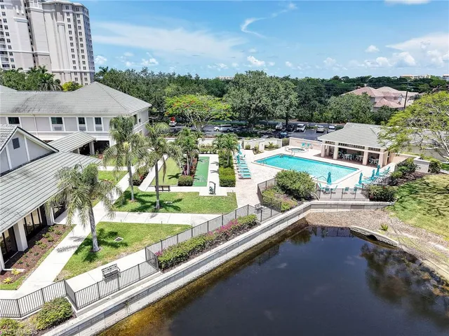 an aerial view of residential houses with yard and ocean view