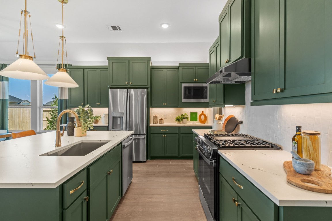 130 Afton June Drive Rosenberg, TX 77471 - Photo 9 of 36 a kitchen with stainless steel appliances granite countertop a sink counter space cabinets and a table