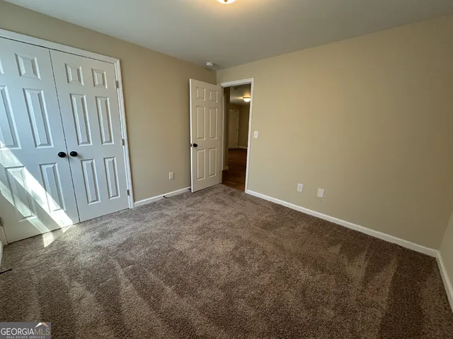 a view of an empty room with staircase