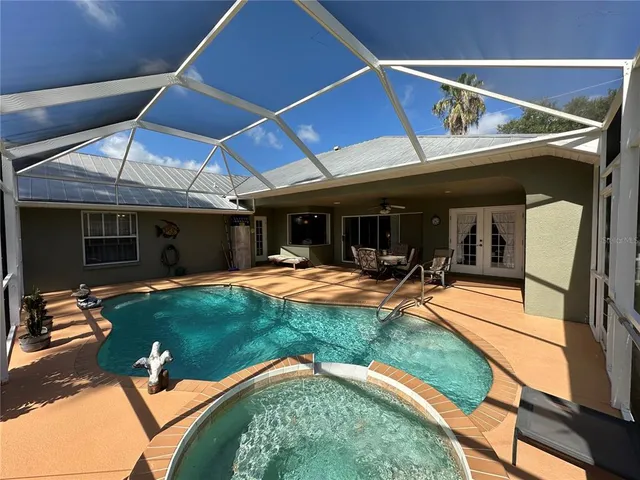 a view of a backyard with table and chairs under an umbrella
