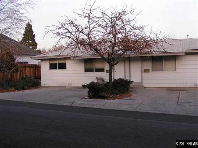a house that has a tree in front of it