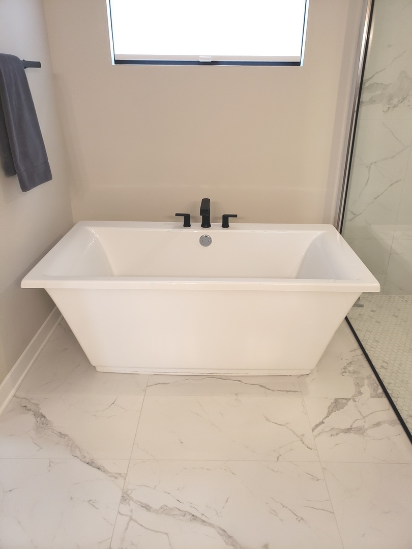 4327 Carpenter Road Naperville, IL 60564 - Photo 25 of 42 a white bath tub sitting in a bathroom