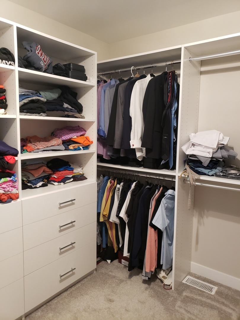 4327 Carpenter Road Naperville, IL 60564 - Photo 26 of 42 a view of walk in closet with clothes and shoes
