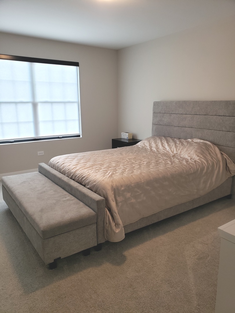 4327 Carpenter Road Naperville, IL 60564 - Photo 30 of 42 a bed sitting in a bedroom next to a window