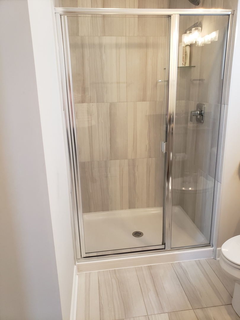 4327 Carpenter Road Naperville, IL 60564 - Photo 36 of 42 a bathroom with a shower and a sink