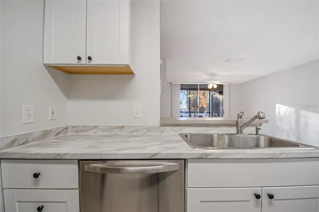 a sink with a granite countertop white sink and vanity