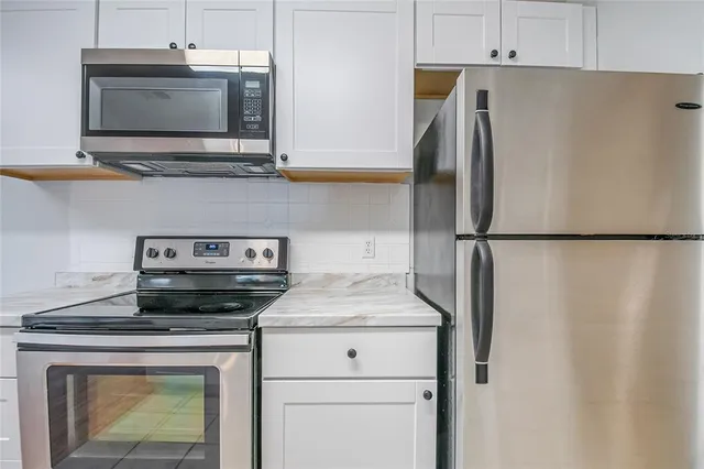 a kitchen with a stove and a microwave