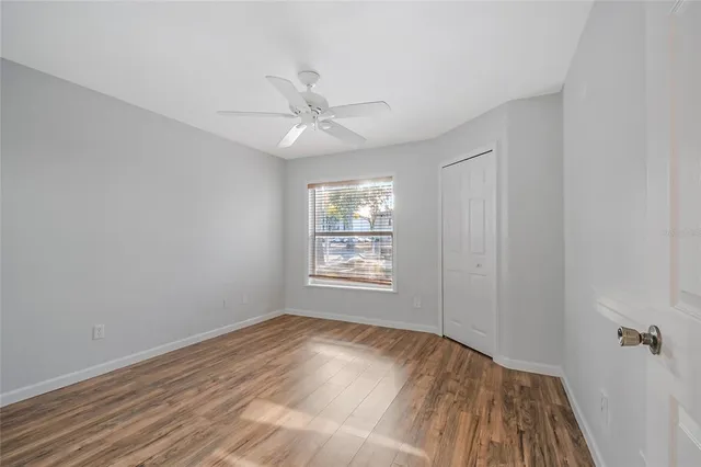 wooden floor in an empty room with a window