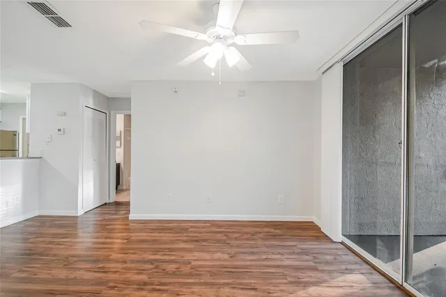 a view of an empty room with wooden floor