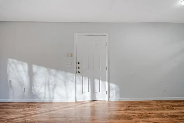 a view of wooden floor and cabinet in a room