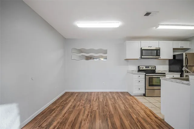 a kitchen with a refrigerator and a stove top oven