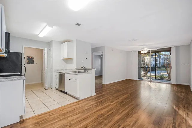 a kitchen with granite countertop a stove a sink and a refrigerator