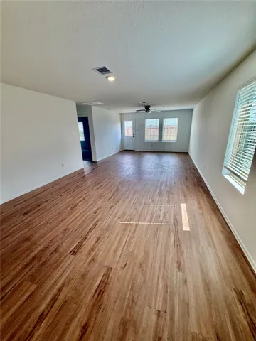 wooden floor in an empty room with a window