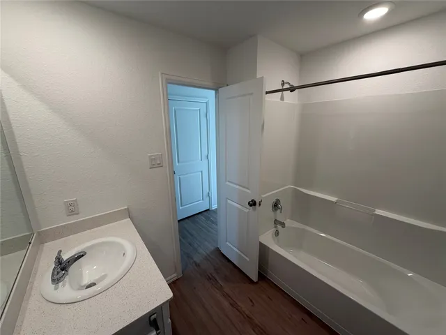 a bathroom with a bathtub and a sink