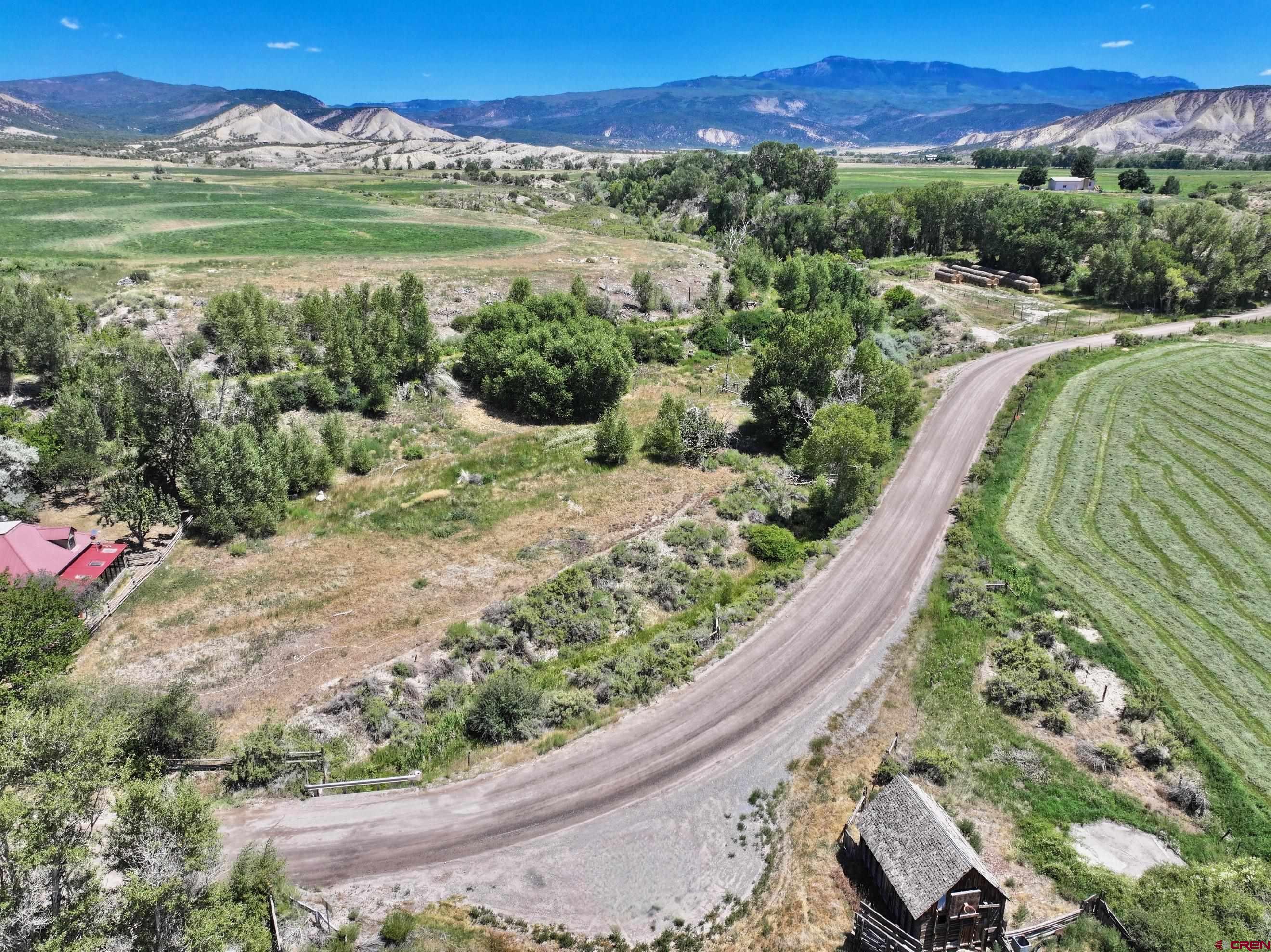 Tbd Lot 3 Uncompahgre Road Montrose, CO 81403 - Photo 2 of 9 a view of a lush green hillside and a houses