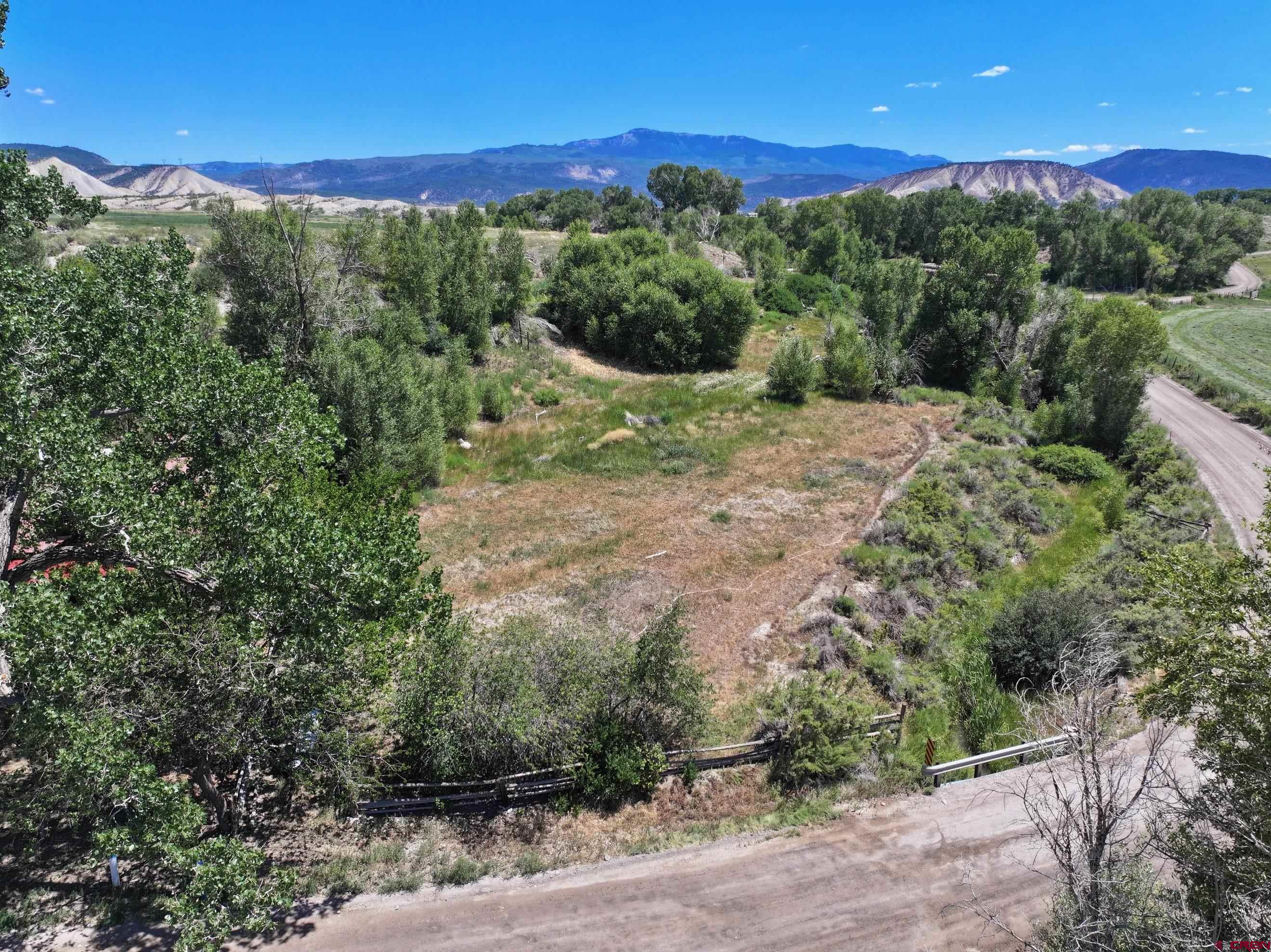 Tbd Lot 3 Uncompahgre Road Montrose, CO 81403 - Photo 4 of 9 a view of a city with lush green forest