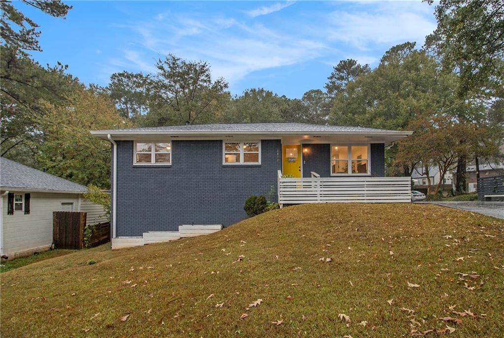 a house that has a tree in front of it