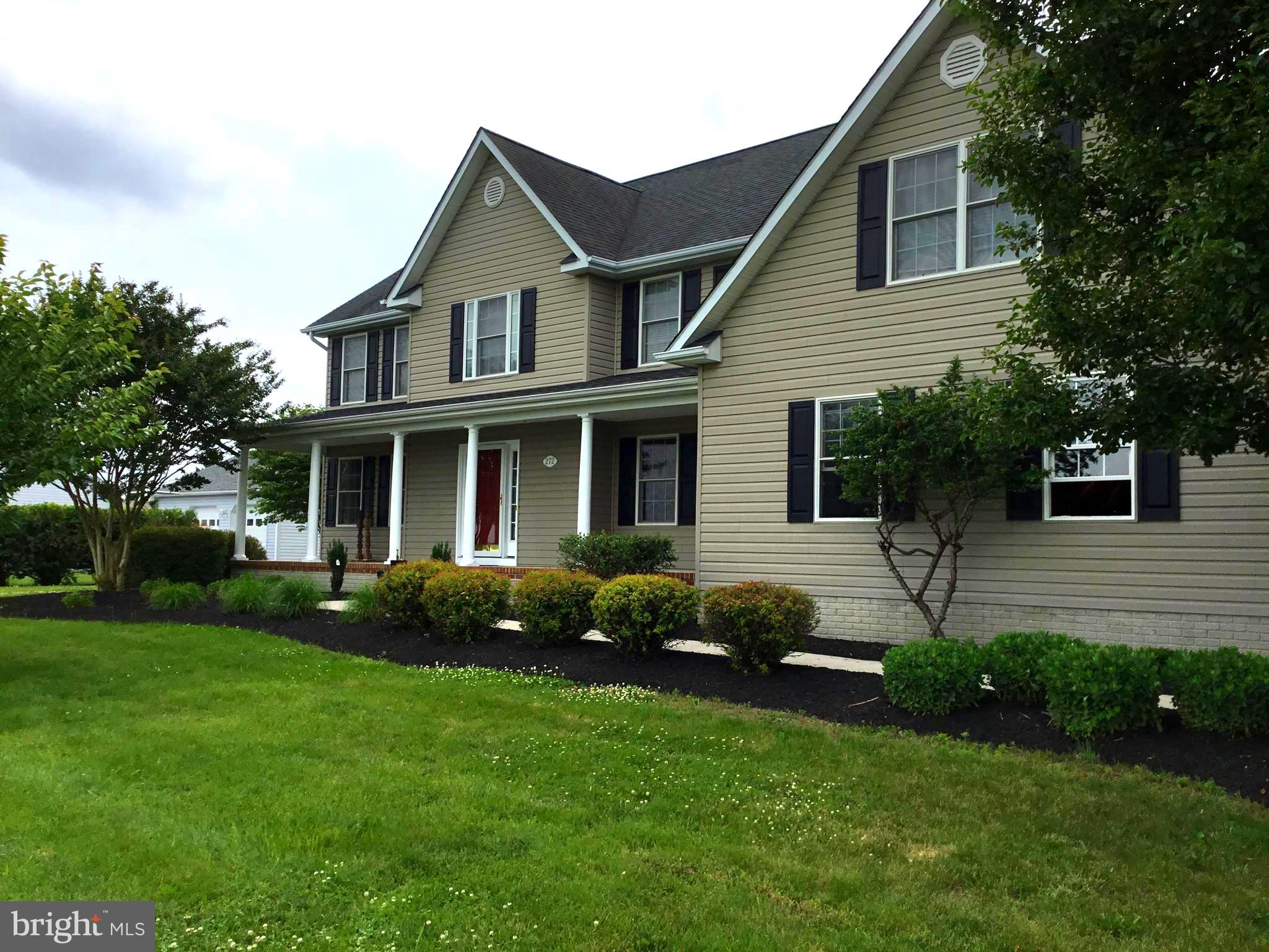 a view of a house with a yard and plants