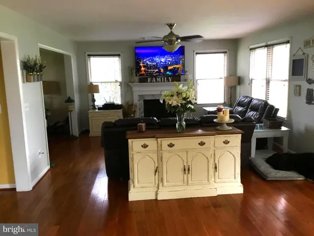 a view of a kitchen with microwave and wooden floor