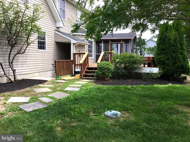 a house view with a sitting space and garden