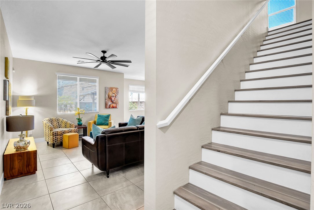 9688 Rankin Rdg Court Las Vegas, NV 89178 - Photo 20 of 53 A graceful staircase with contrasting treads complements the naturally illuminated living area with tiled flooring.