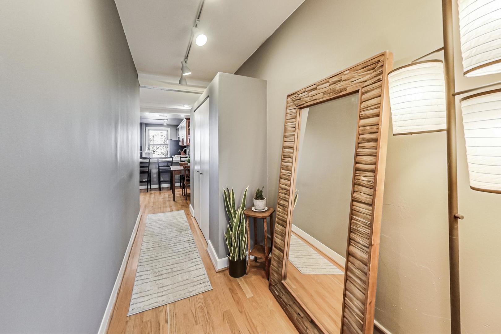 725 West Sheridan Road, Unit 601 Chicago, IL 60613 - Photo 17 of 23 a view of a hallway with wooden floor and a window