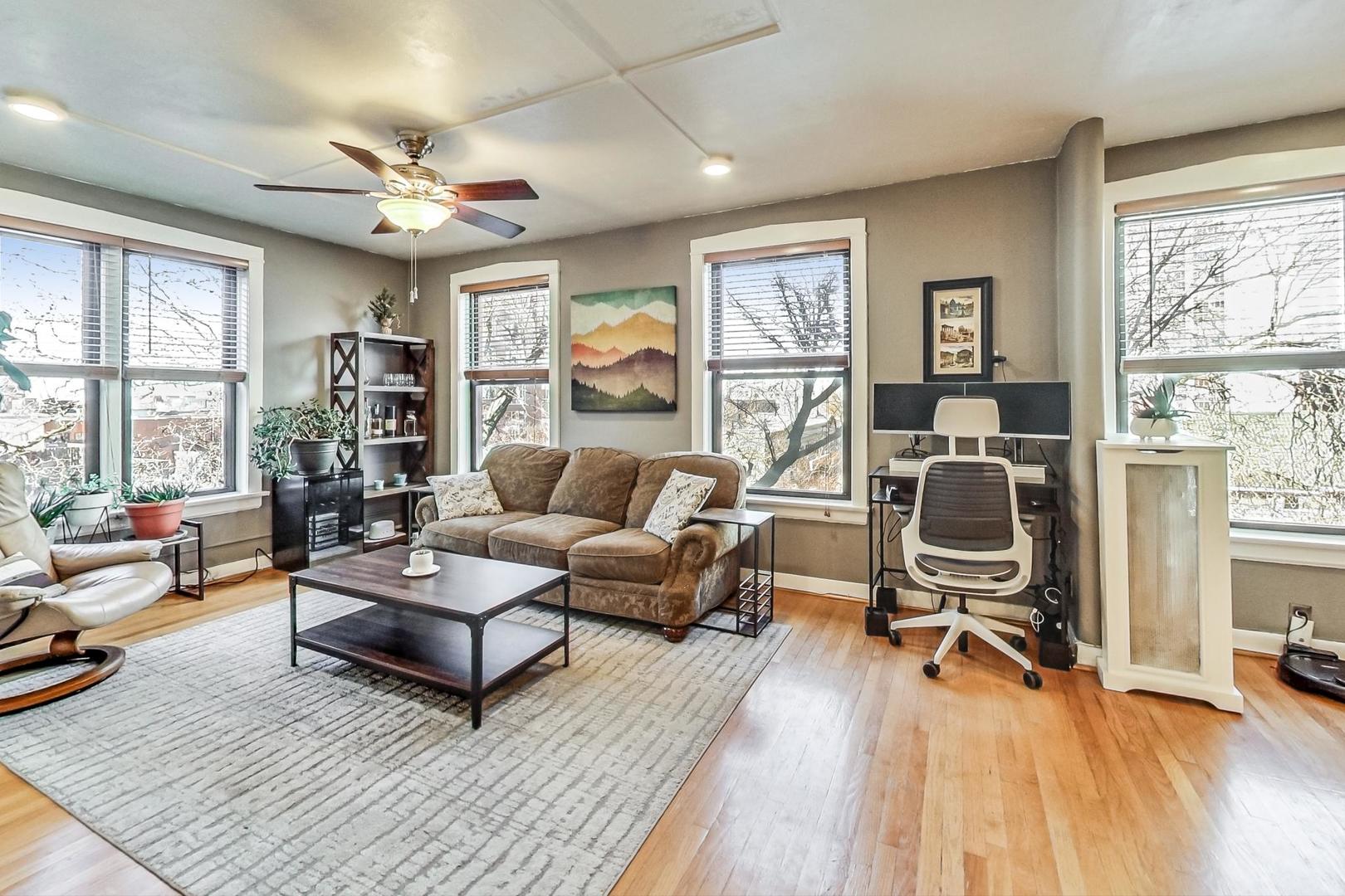 725 West Sheridan Road, Unit 601 Chicago, IL 60613 - Photo 3 of 23 a living room with furniture a wooden floor and a window
