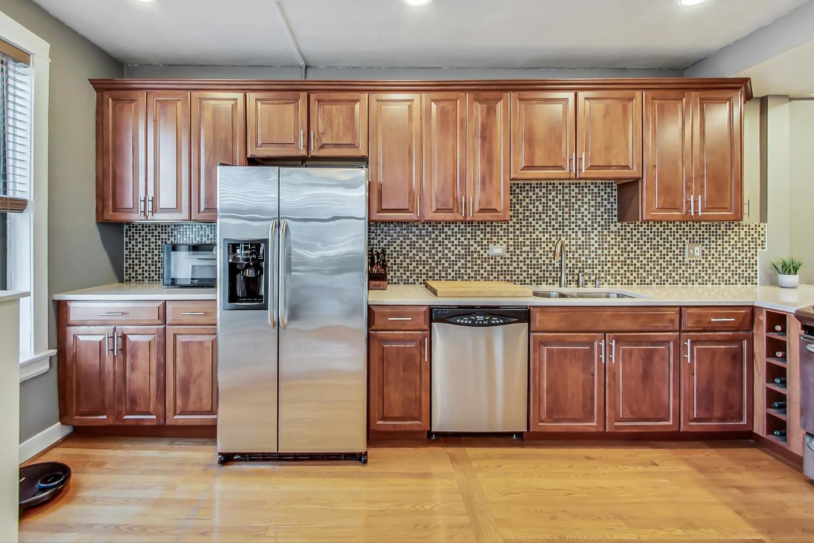 725 West Sheridan Road, Unit 601 Chicago, IL 60613 - Photo 5 of 23 a kitchen with stainless steel appliances granite countertop a refrigerator sink and cabinets