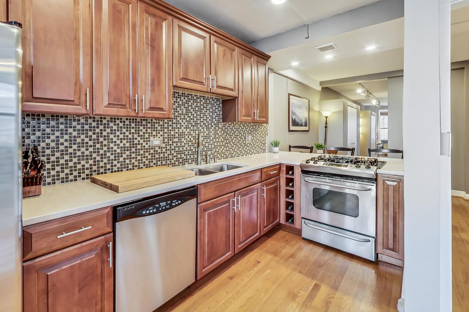 725 West Sheridan Road, Unit 601 Chicago, IL 60613 - Photo 7 of 23 a kitchen with a sink stove and cabinets