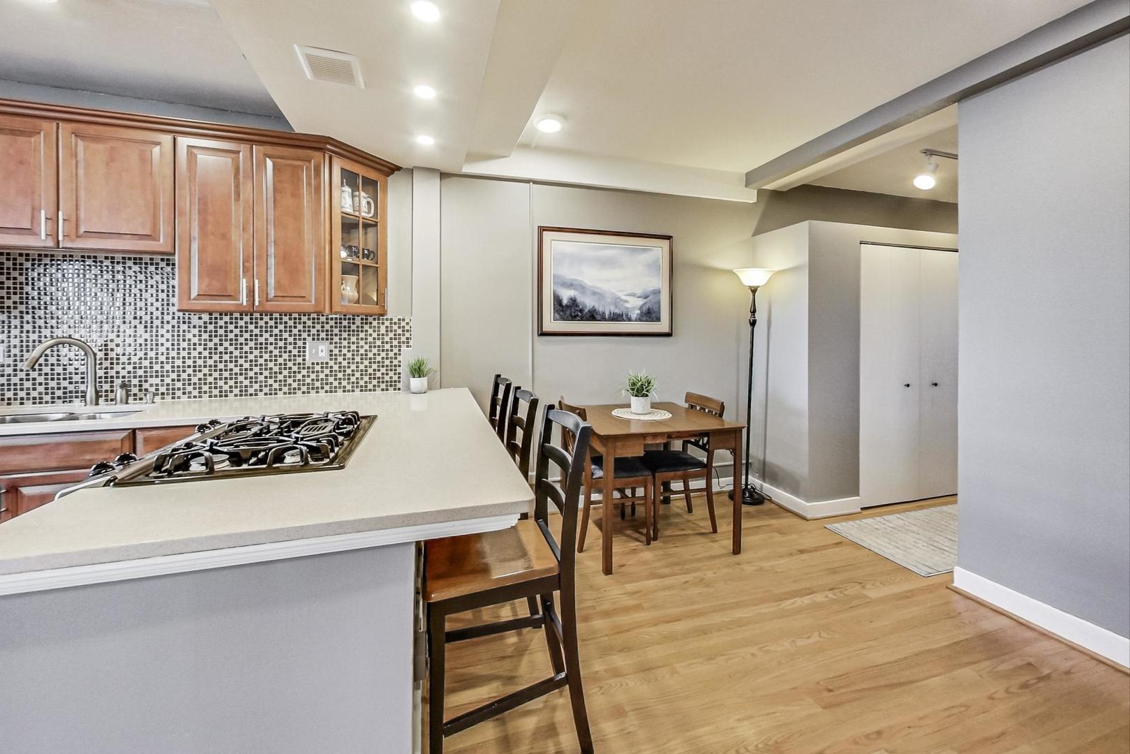 725 West Sheridan Road, Unit 601 Chicago, IL 60613 - Photo 8 of 23 a kitchen with a table and chairs in it