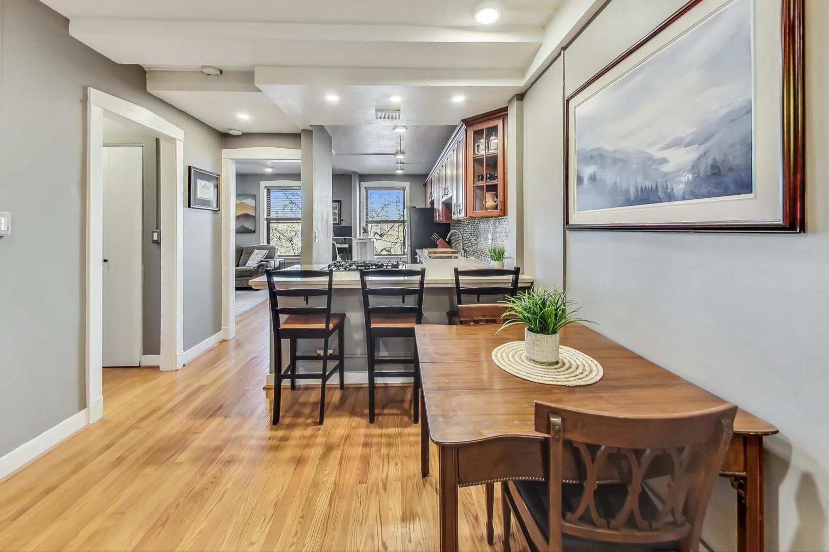 725 West Sheridan Road, Unit 601 Chicago, IL 60613 - Photo 10 of 23 a view of a dining room with furniture and wooden floor