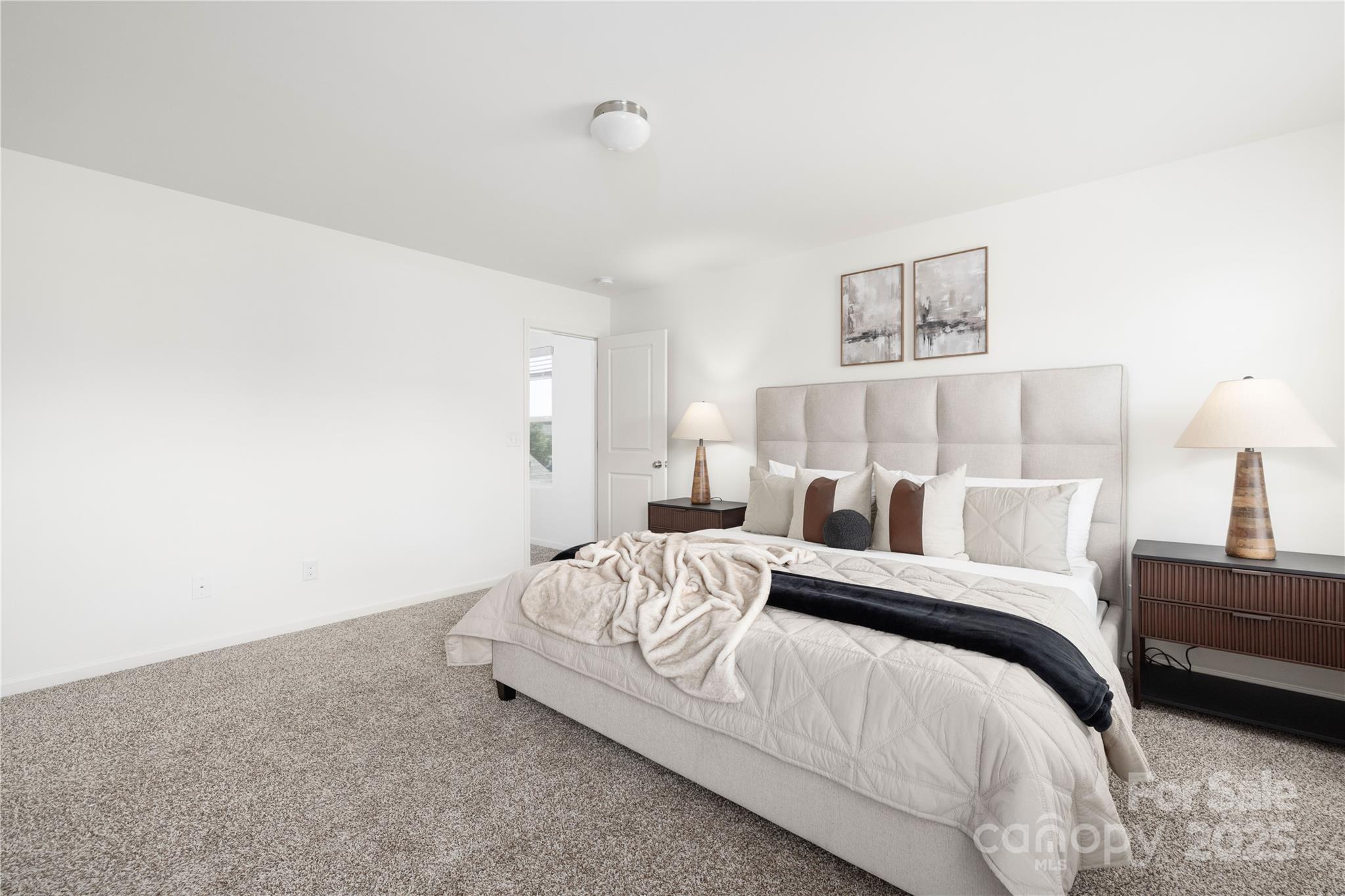 12548 Gotland Road, Unit 327 Midland, NC 28107 - Photo 18 of 31 a bedroom with a bed and a lamp